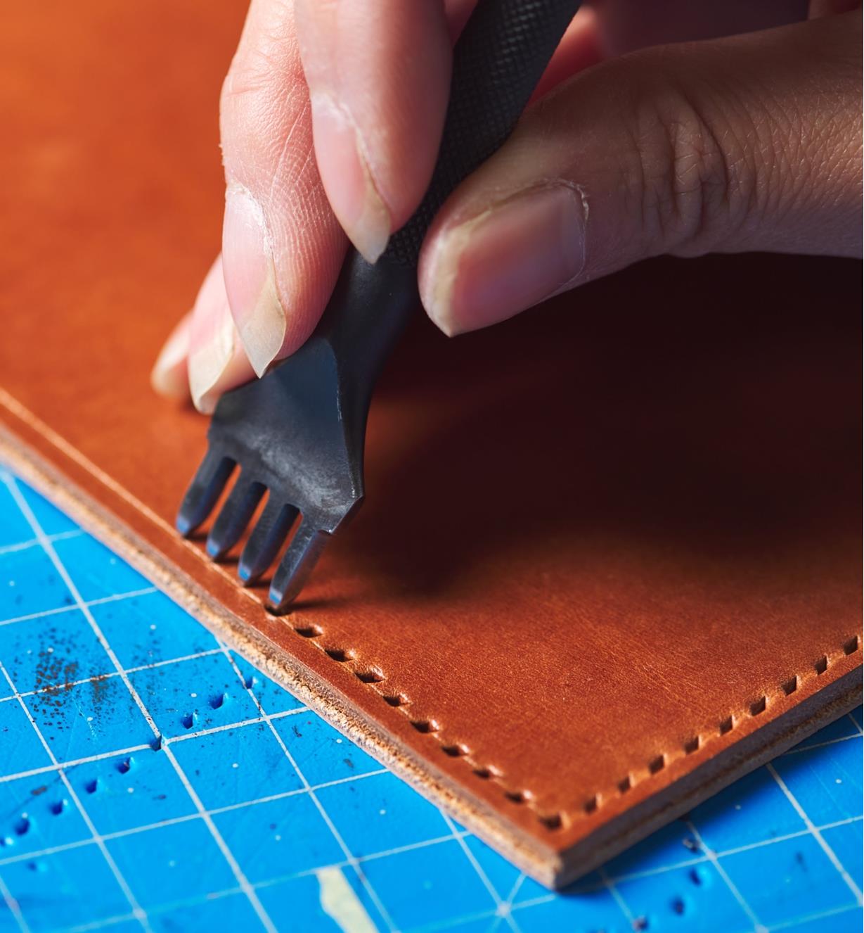 Making the stitch holes with the four-point stitching chisel