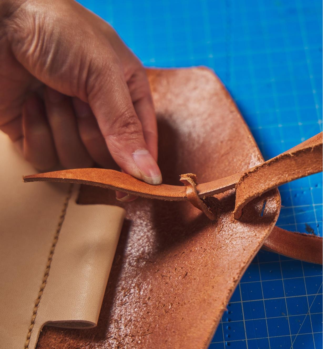 Attaching the leather tie on the leather journal cover