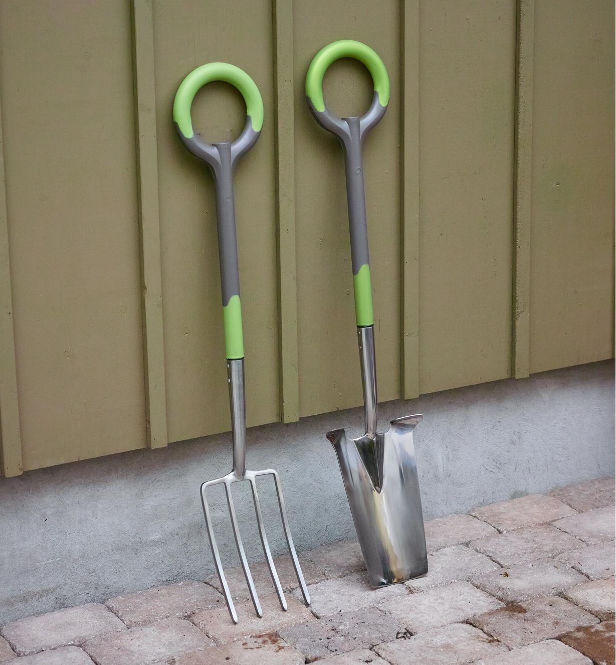 Radius ergonomic stainless-steel digging spade and fork leaning against a wall