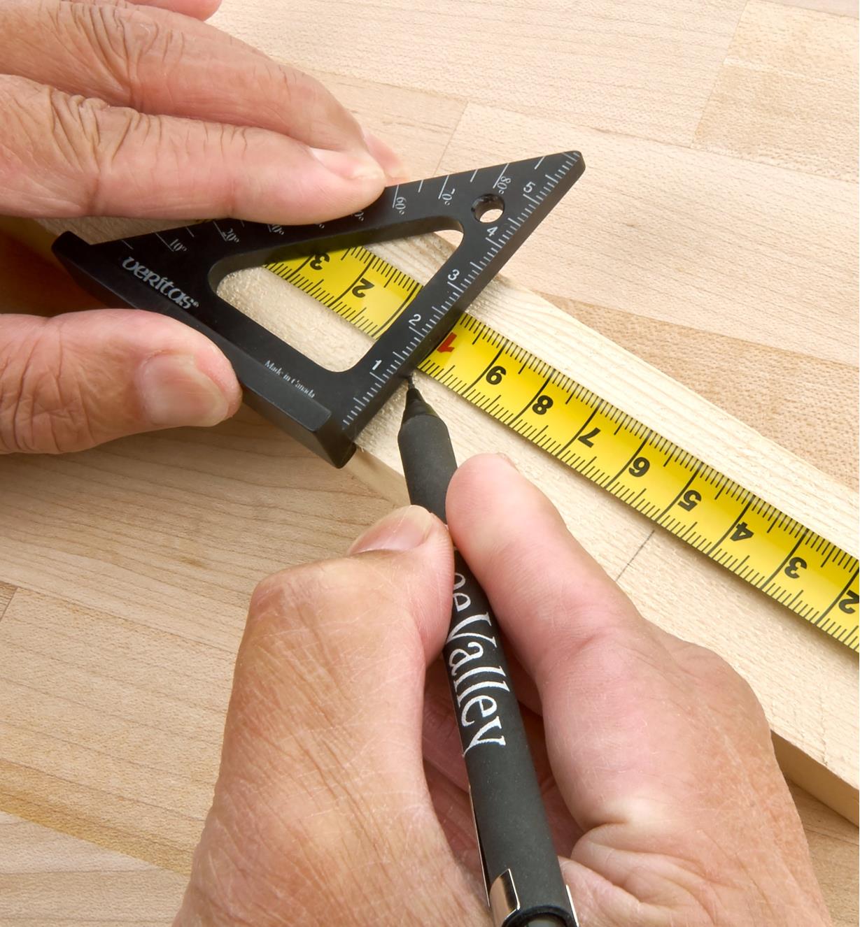 Using a Veritas 60mm Pocket Layout Square over a tape measure to strike a line on a workpiece