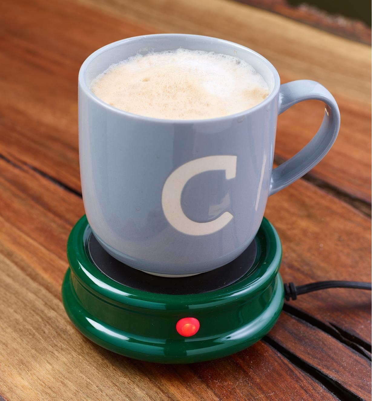 A full mug on a tabletop warmer