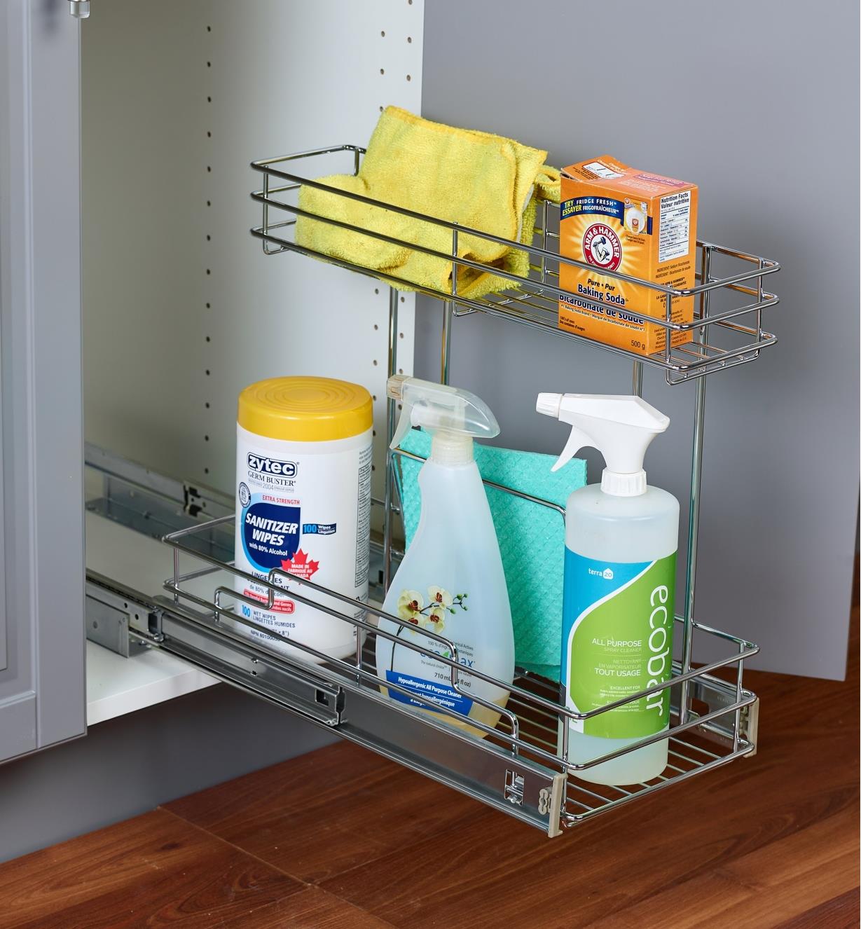 Under-sink unit holding cleaning supplies, installed in a kitchen cupboard