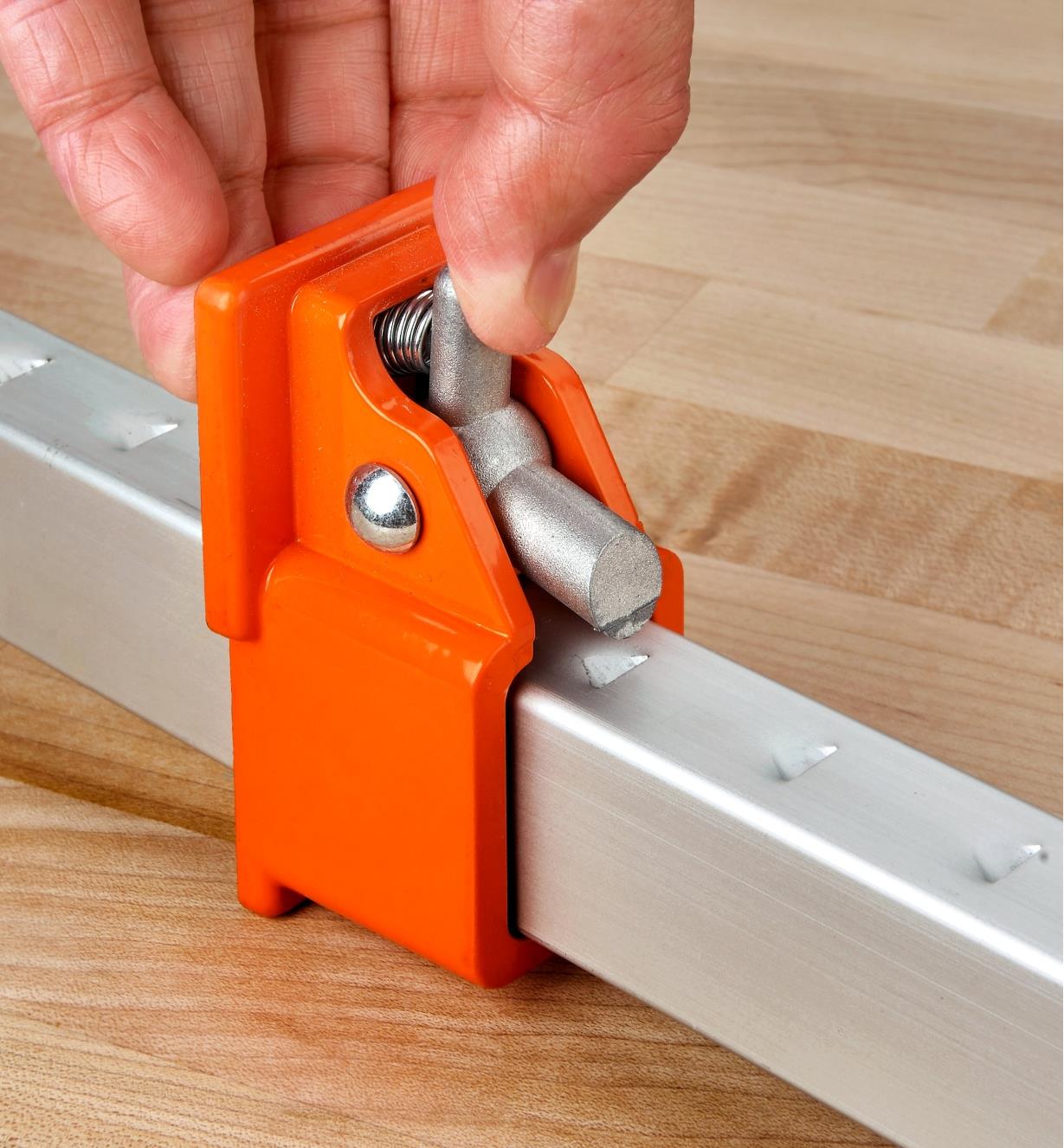 Squeezing the release trigger on the movable head of a Jorgensen aluminum bar clamp