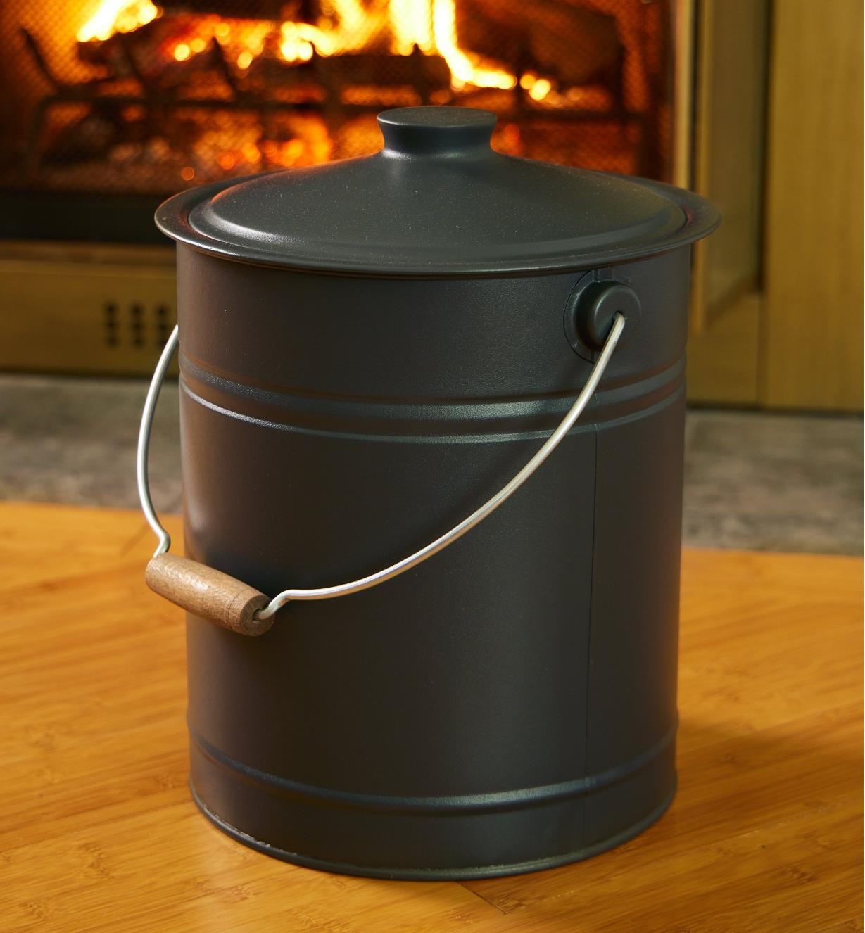 The ash can is placed near a fireplace