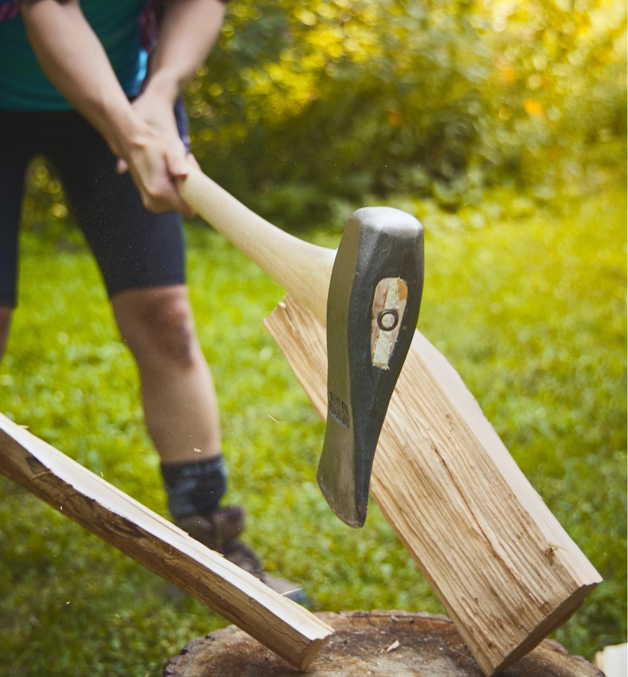 A maul being used to split wood