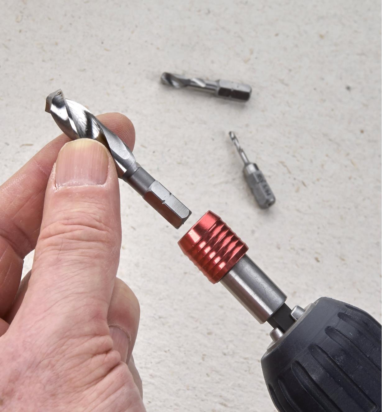 Placing a twist bit into a quick-change bit holder chucked in a drill