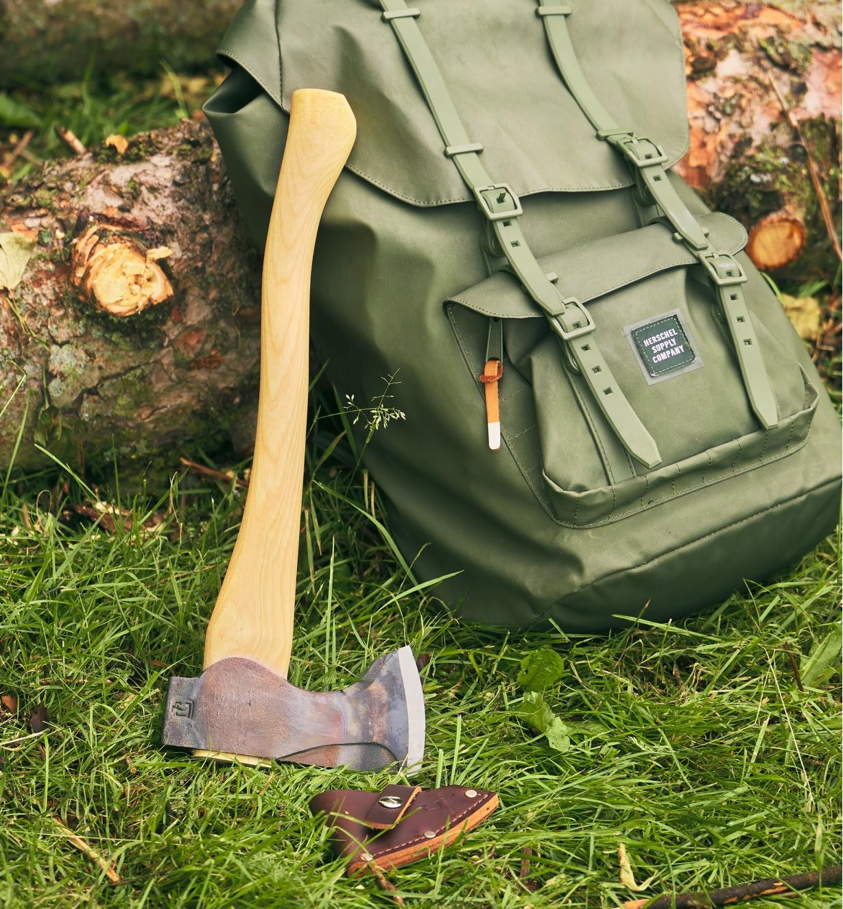 A pack axe leaning against a backpack