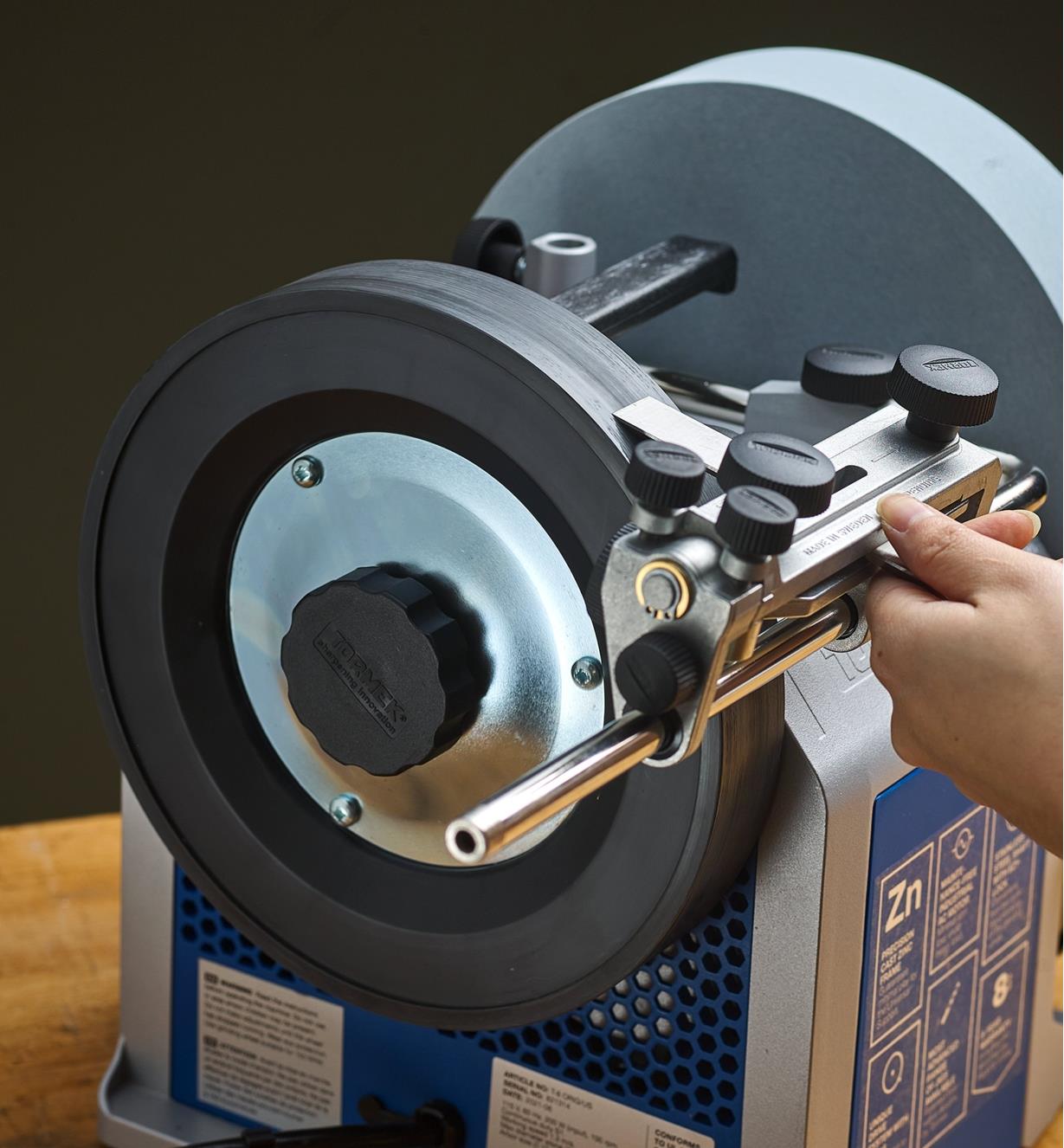 A blade being honed on a composite wheel