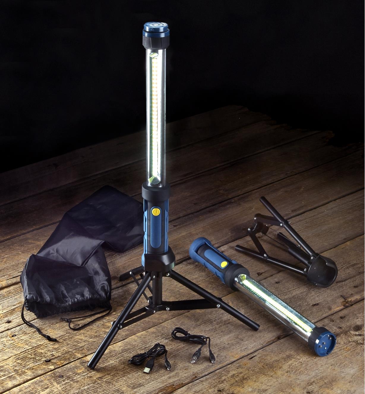 The LED tube lights set arranged on a floor, with one of the LED fixtures mounted on a tripod