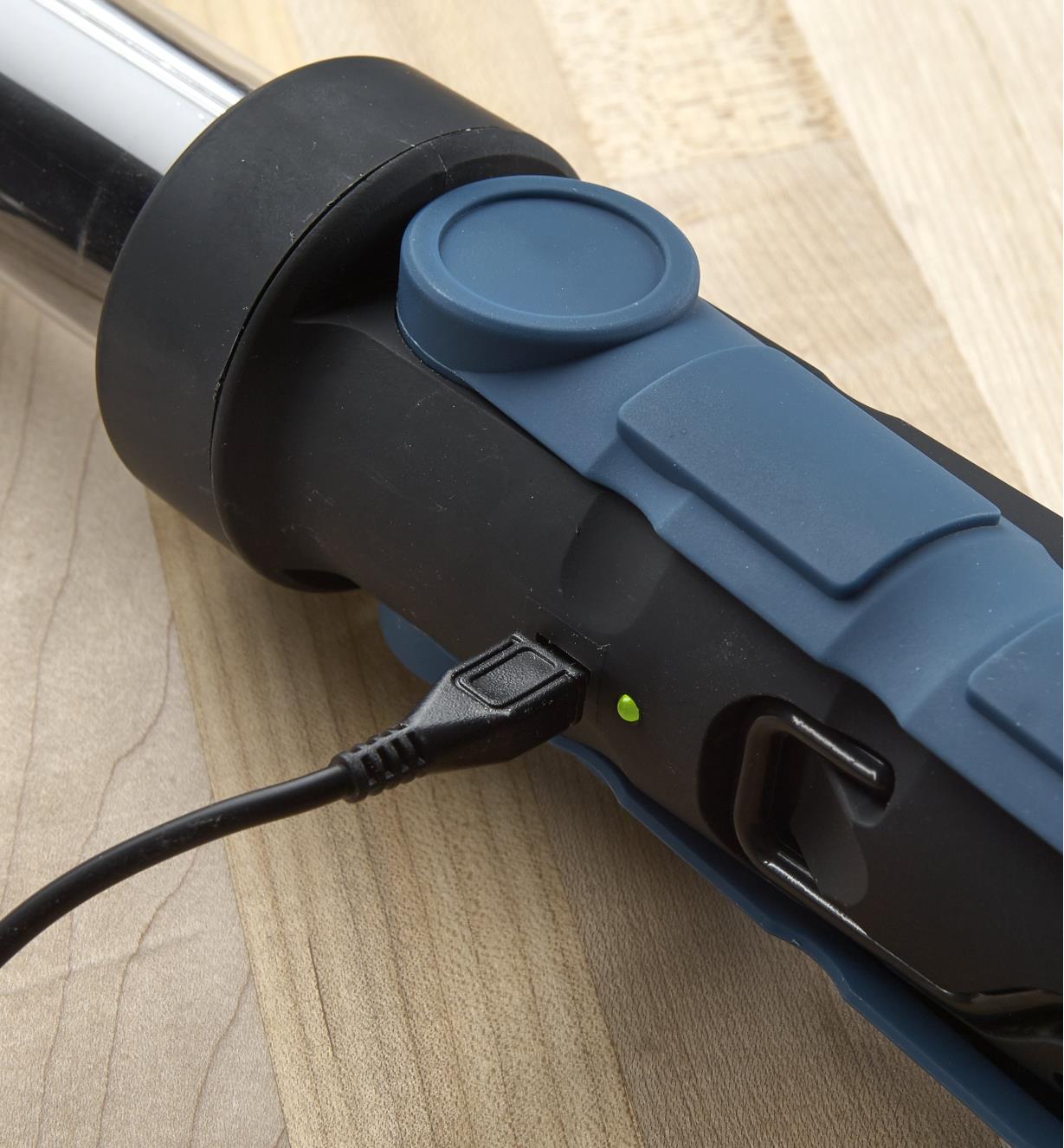 A close-up view of the USB cable plugged into an LED tube light to recharge it