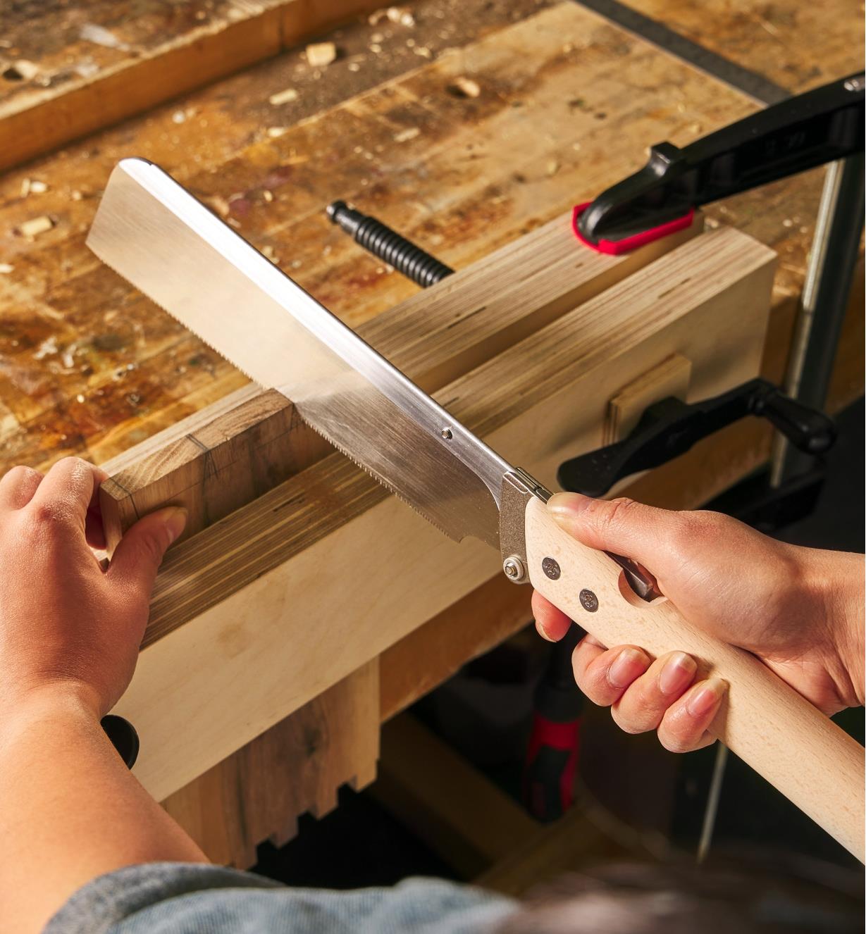 Using a folding dozuki to cut dovetails in clamped stock