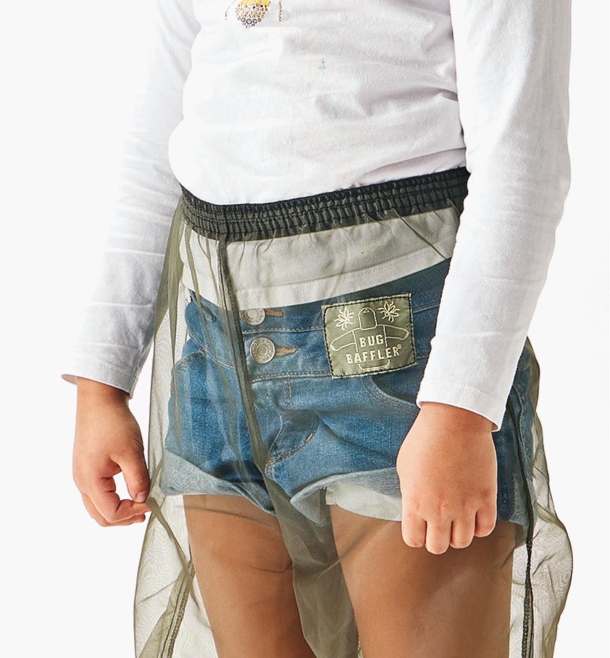 A close-up view of the elastic waistband on a pair of bug-protection pants worn by a child