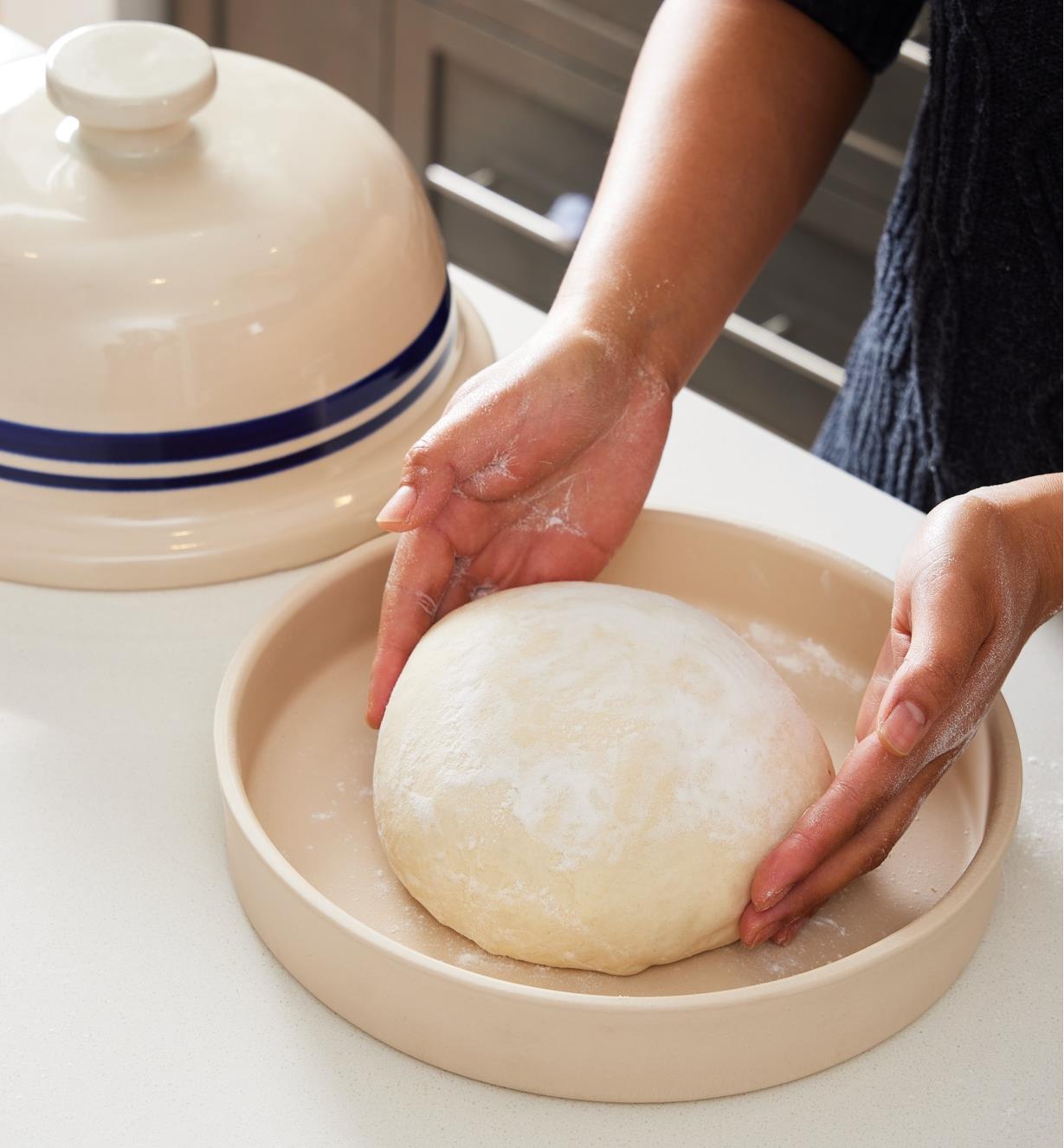 Placing bread dough in the base of the bread-baking cloche