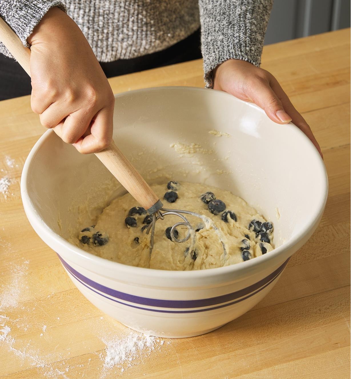 Using a whisk to combine ingredients in the 12"" Dominion mixing bowl