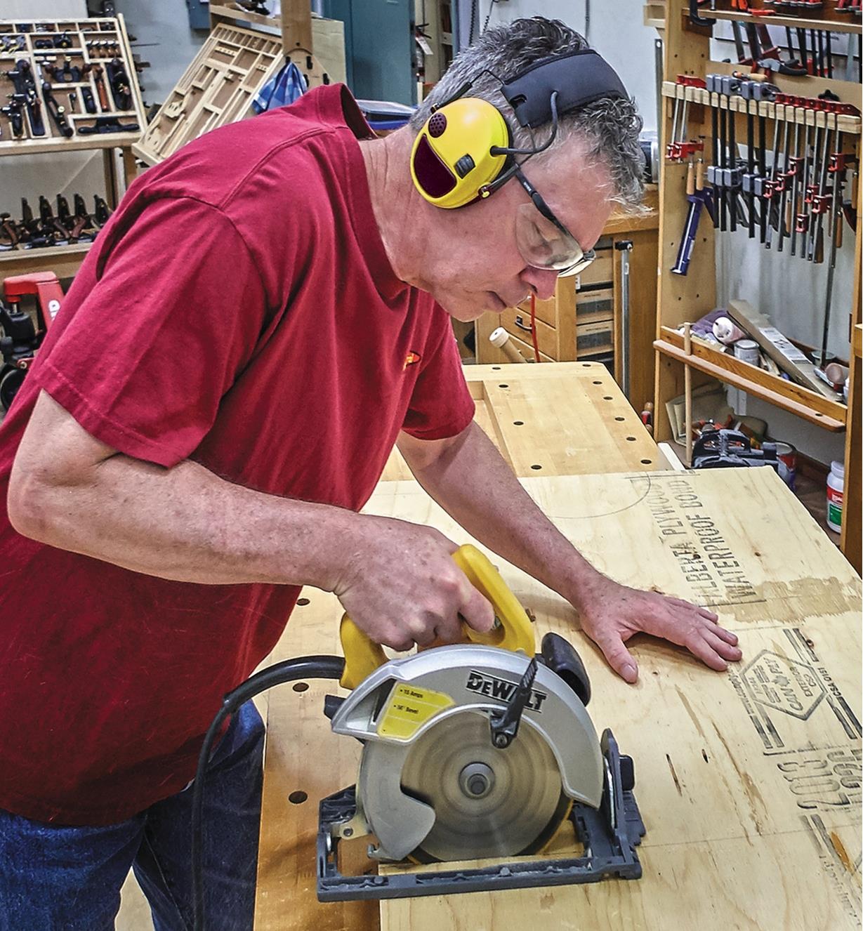 Man wearing active listening hearing protectors in a workshop