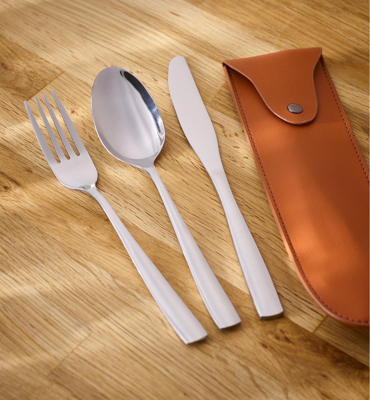 The Portable Cutlery Set – a fork, spoon, knife and simulated leather carrying sheath – lie on a countertop