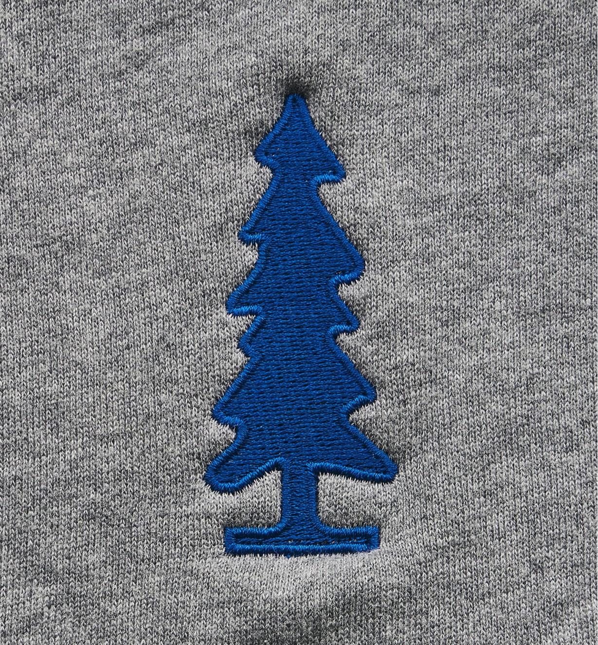 Close-up of tree logo embroidered onto front of sweatshirt