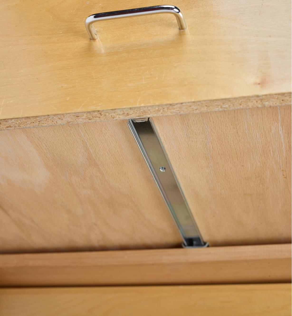 A drawer slide mounted on the underside of a drawer