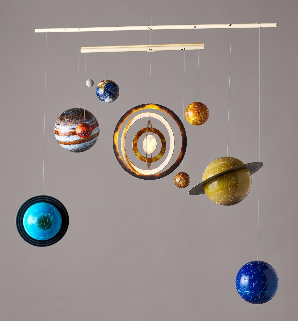 Assembled planets hanging from a mobile, forming a model of the solar system