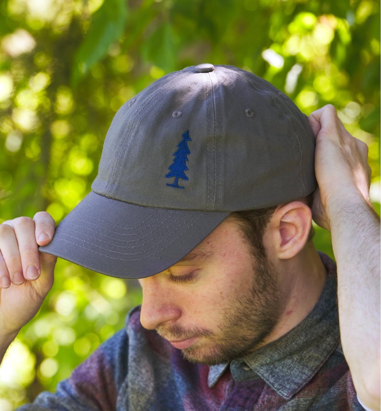 Front view of a model wearing a Lee Valley baseball cap displaying the Lee Valley tree logo on the front