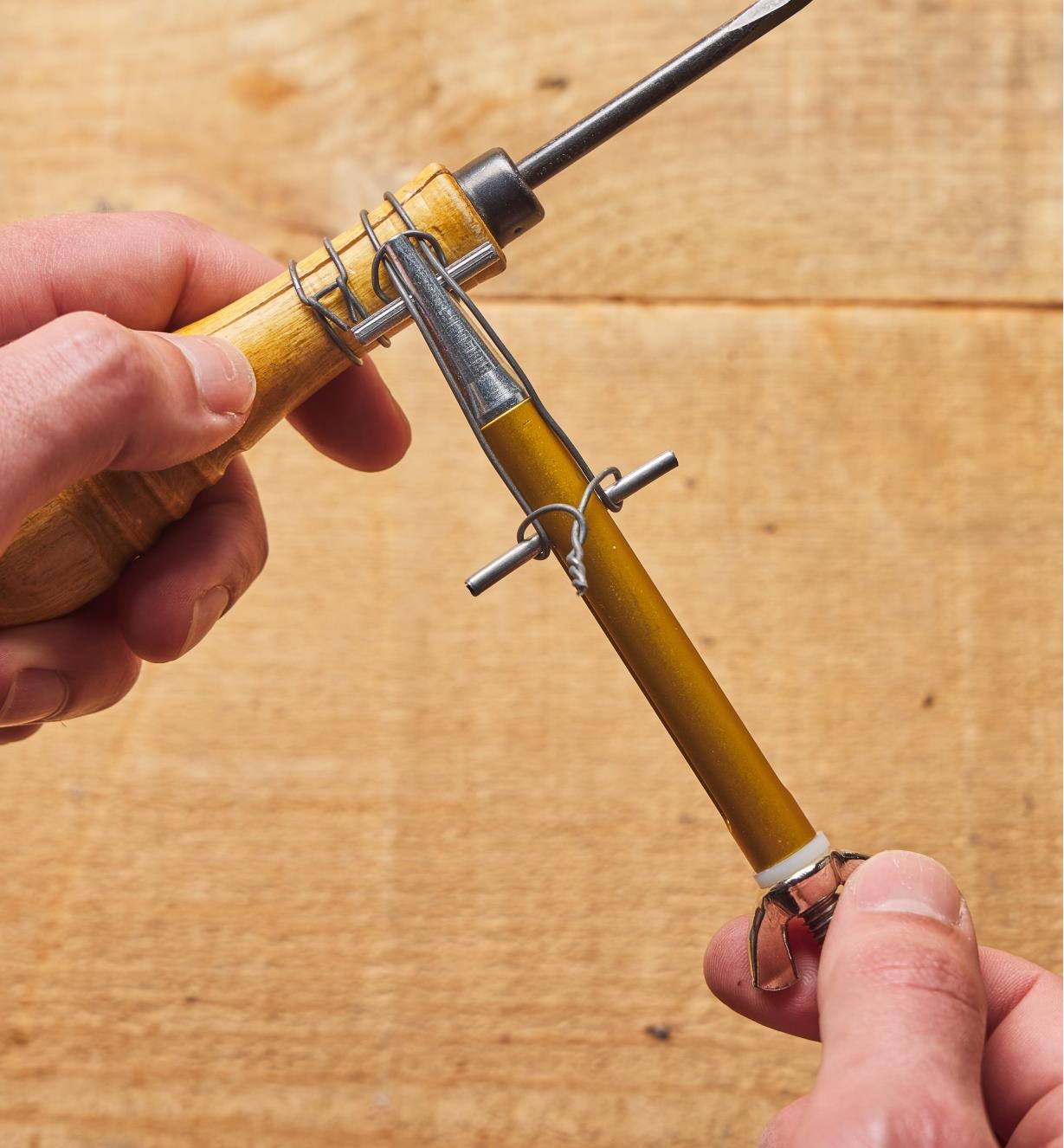 Wire is tightened around a cracked tool handle using the Clamptite Tool 
