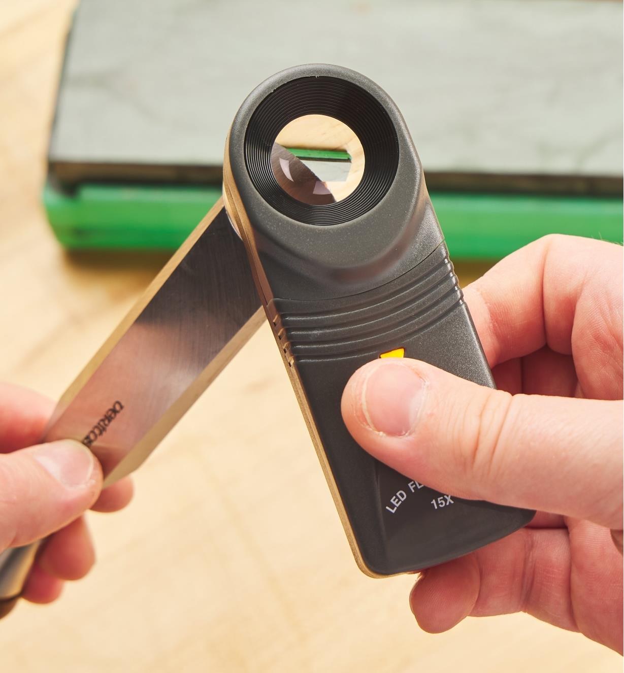 Using a 15-Power Lighted Loupe to examine a chisel blade