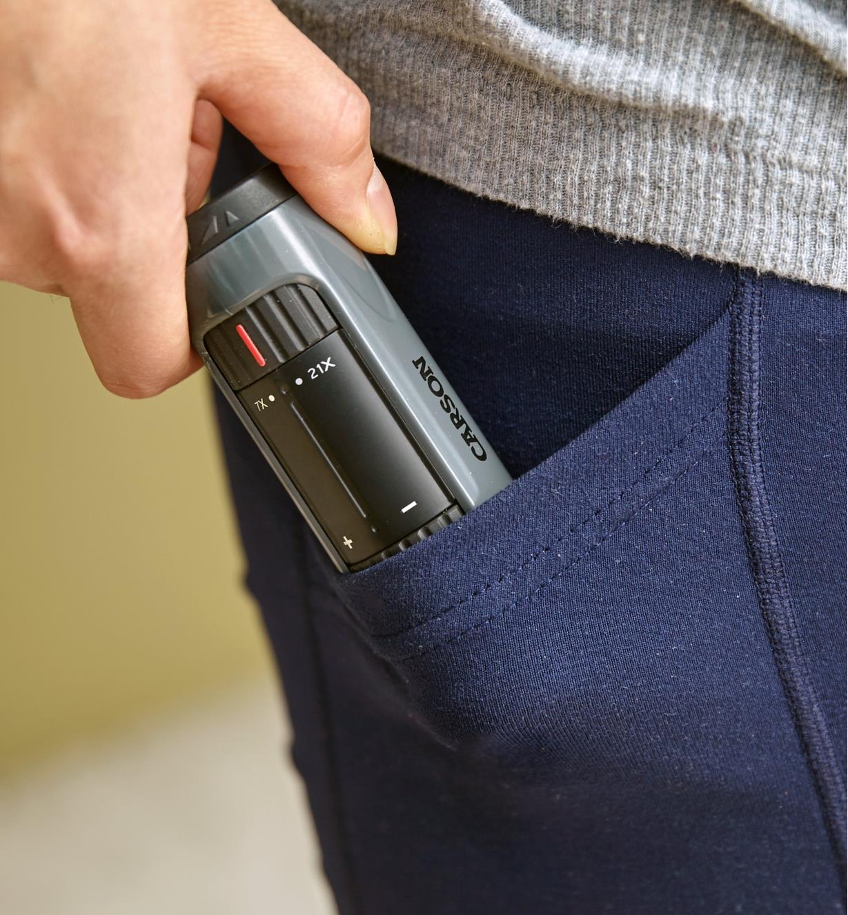 Slipping the zoom monocular into a pants pocket