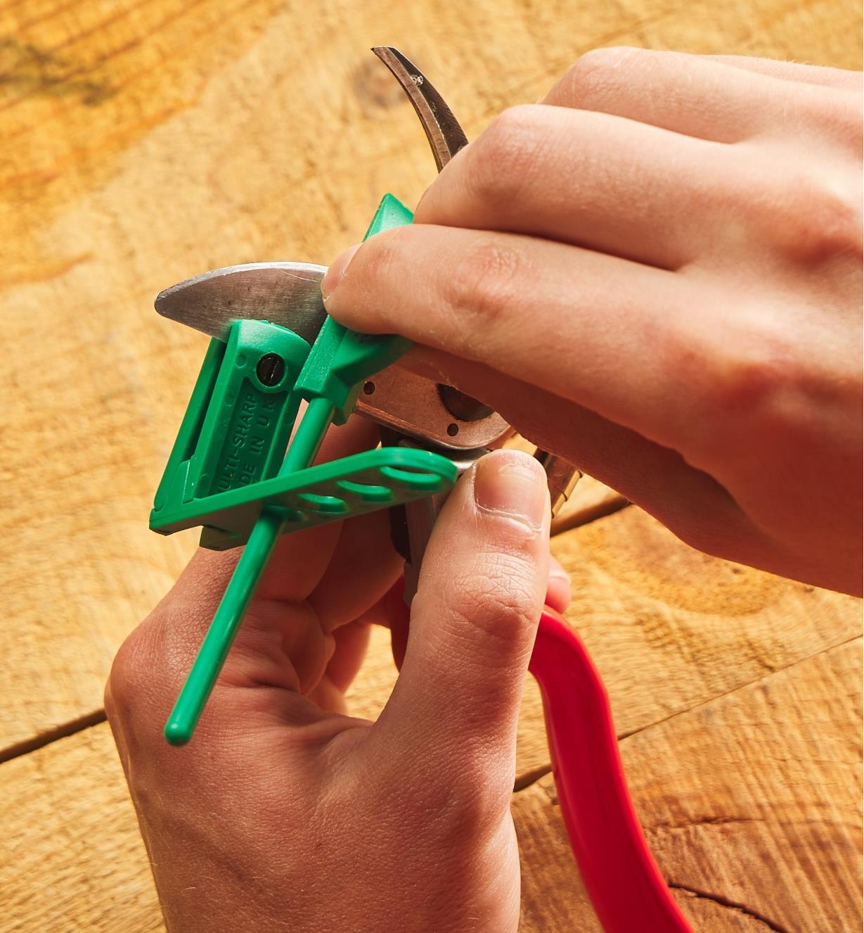 Pruner Sharpener being used to sharpen a hand pruner blade