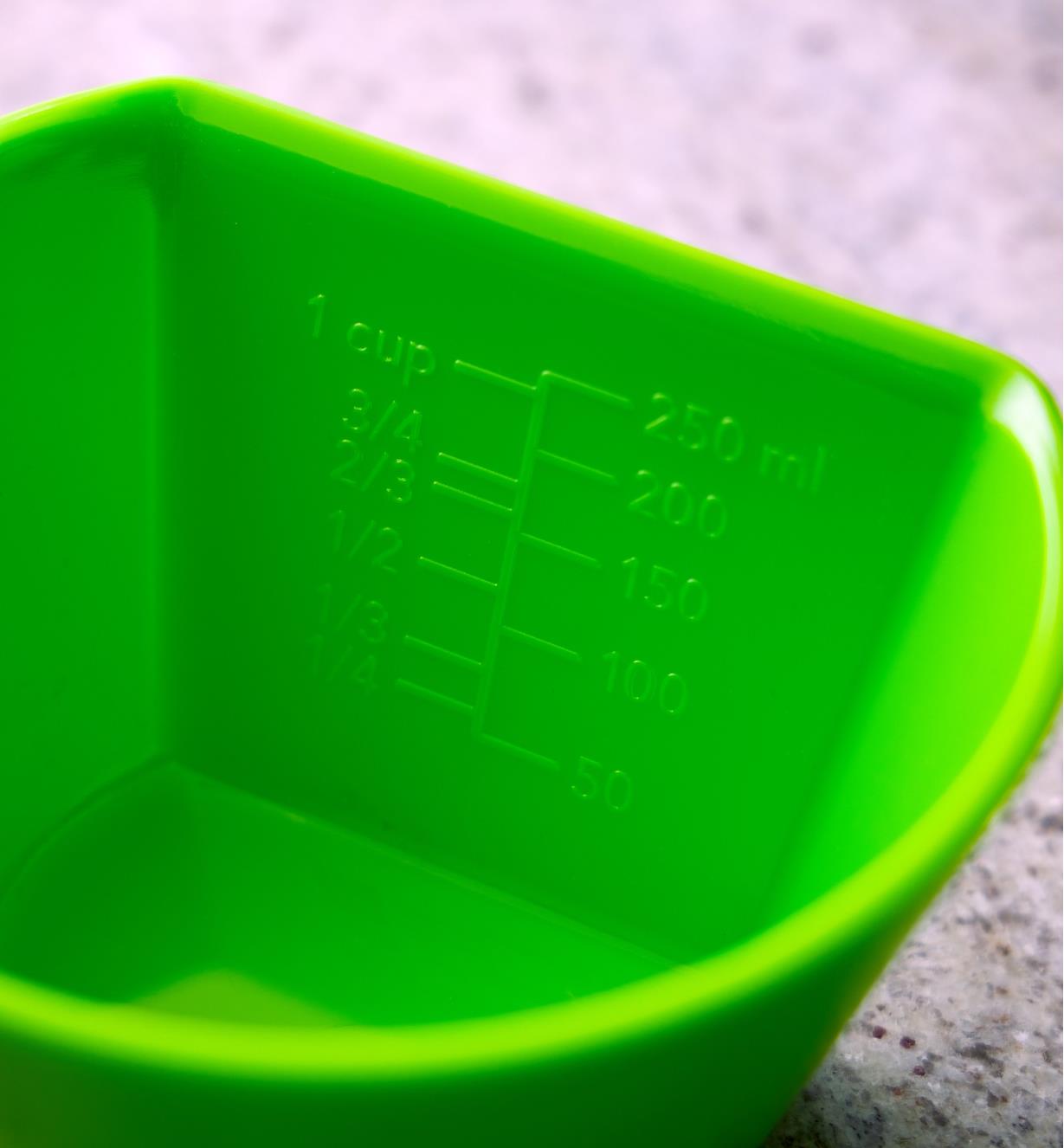 Close-up view of graduations marked on the inside of a scoop measuring bowl