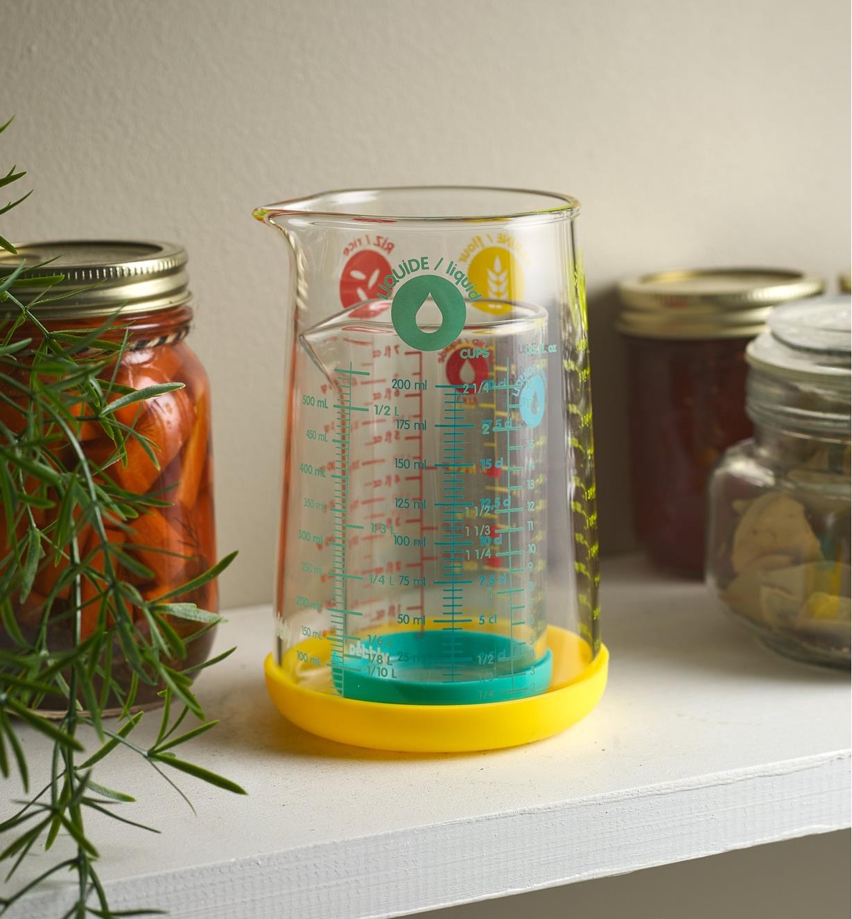 500ml measuring glass on a shelf with a 200ml measuring glass inside it