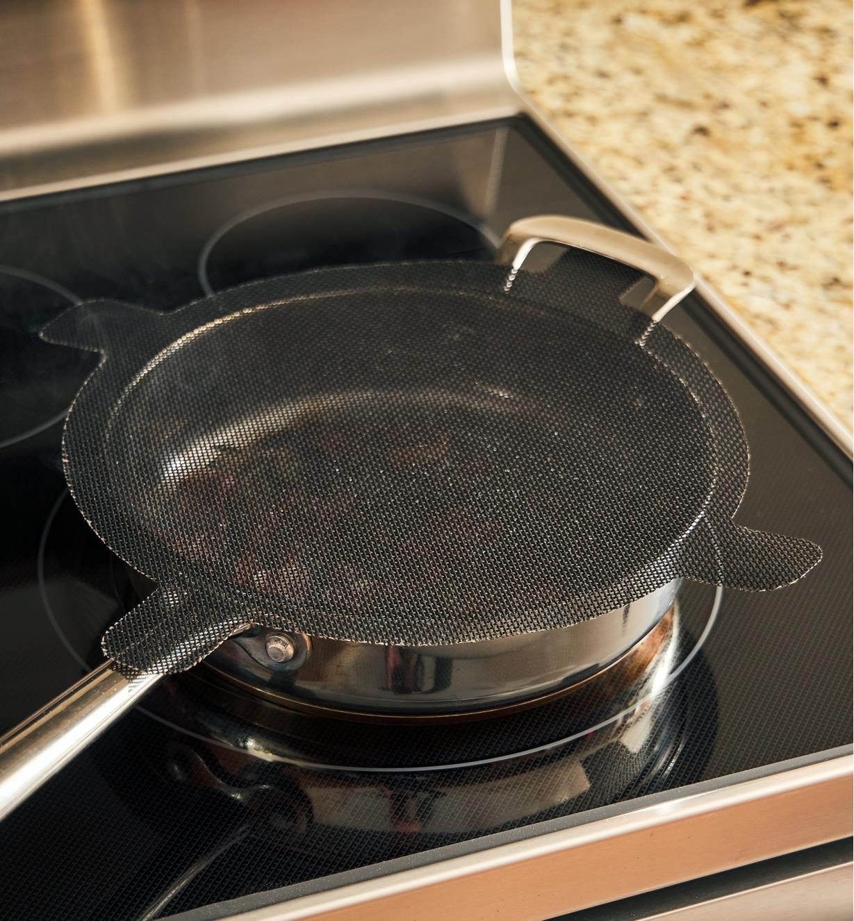 Contents of a pan are visible through the semi-transparent splatter screen