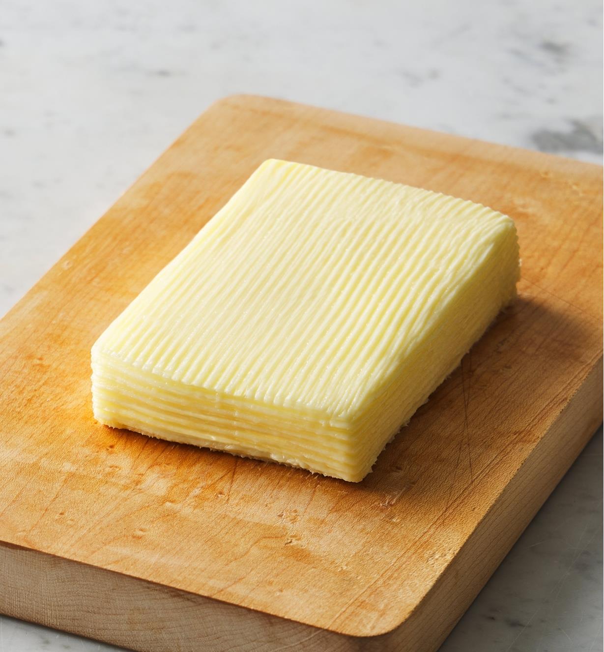 A formed brick of butter on a cutting board