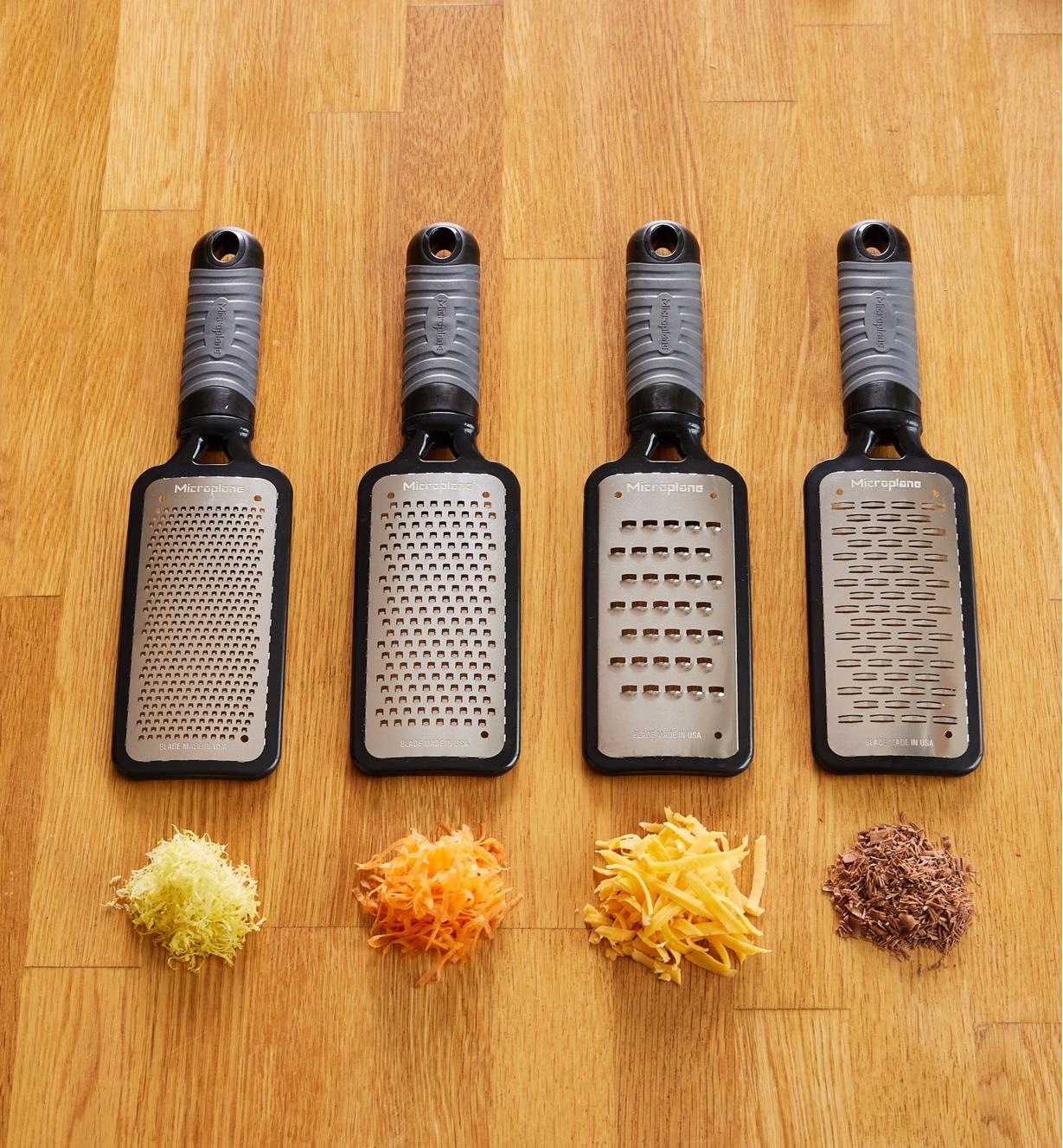 Fine, coarse, ultra-coarse and ribbon paddle graters, each shown with a sample of grated food