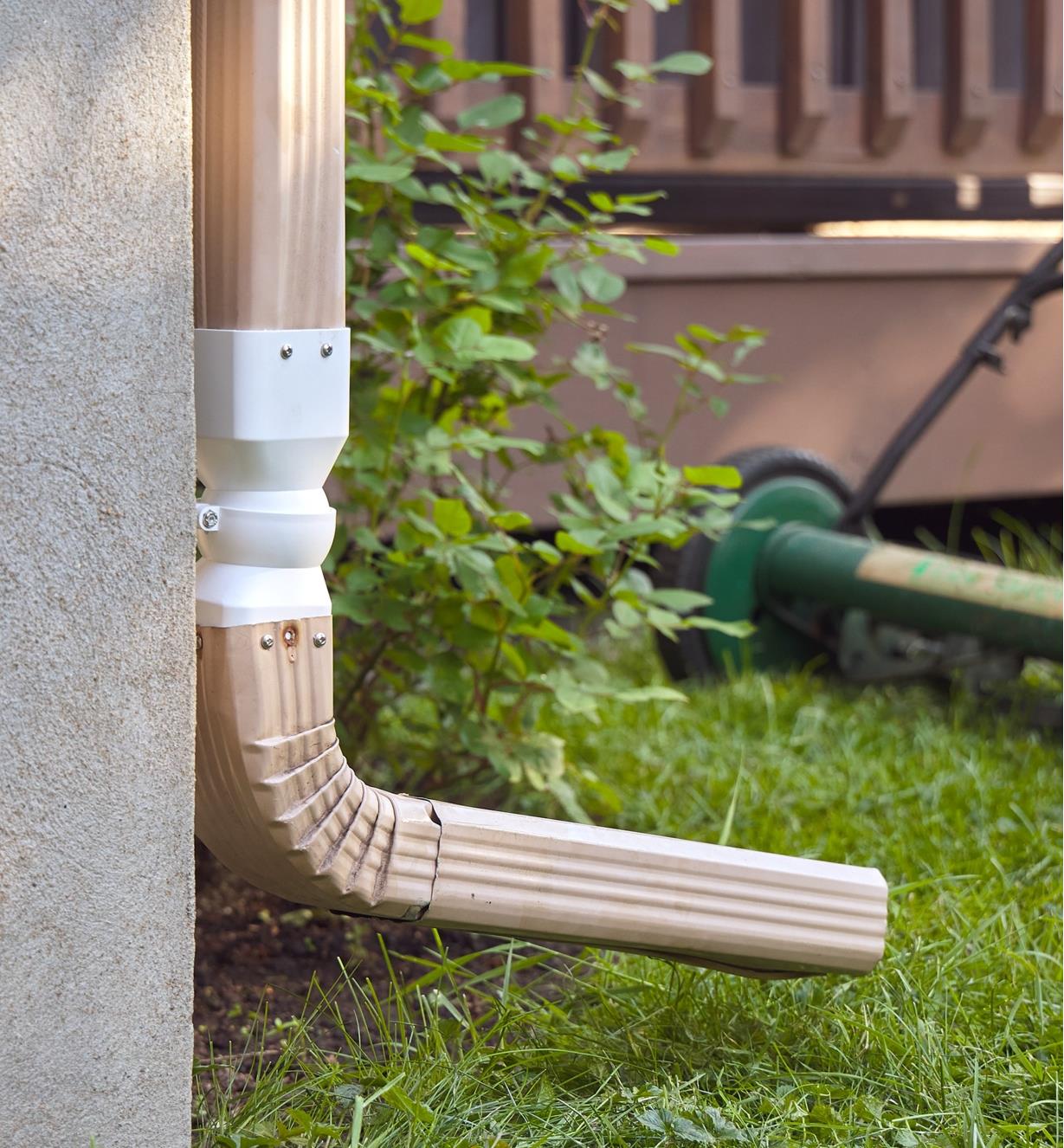 A TurnSpout connected with a downspout at the side of a house