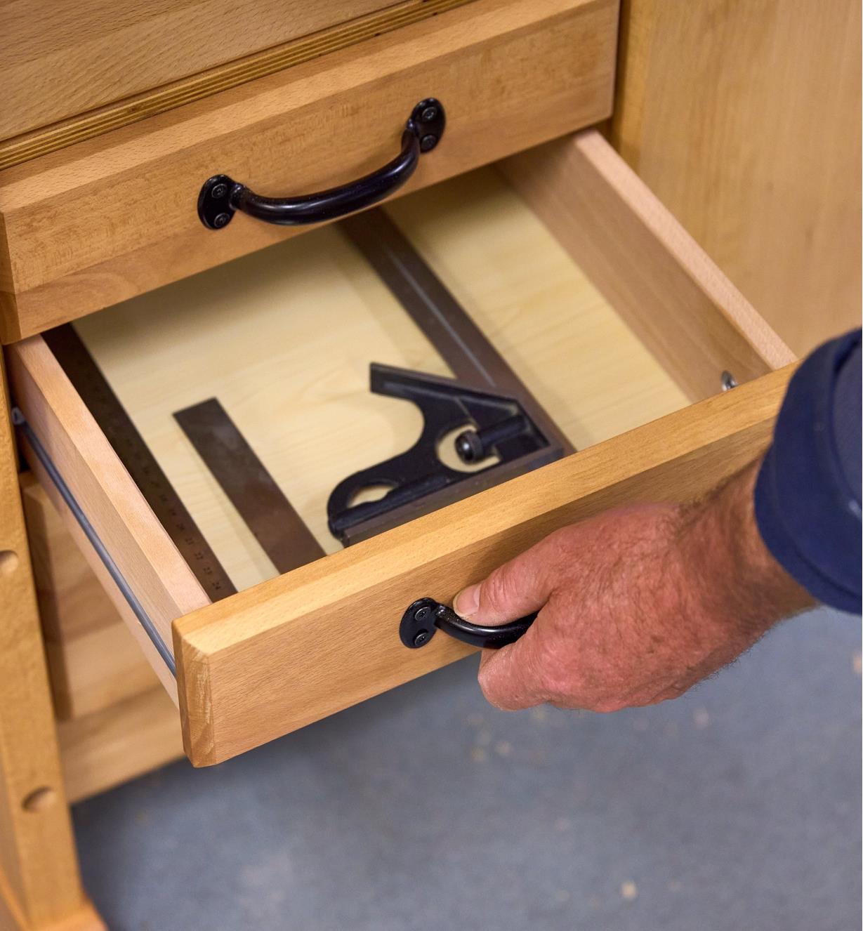 An open drawer with a combination square inside