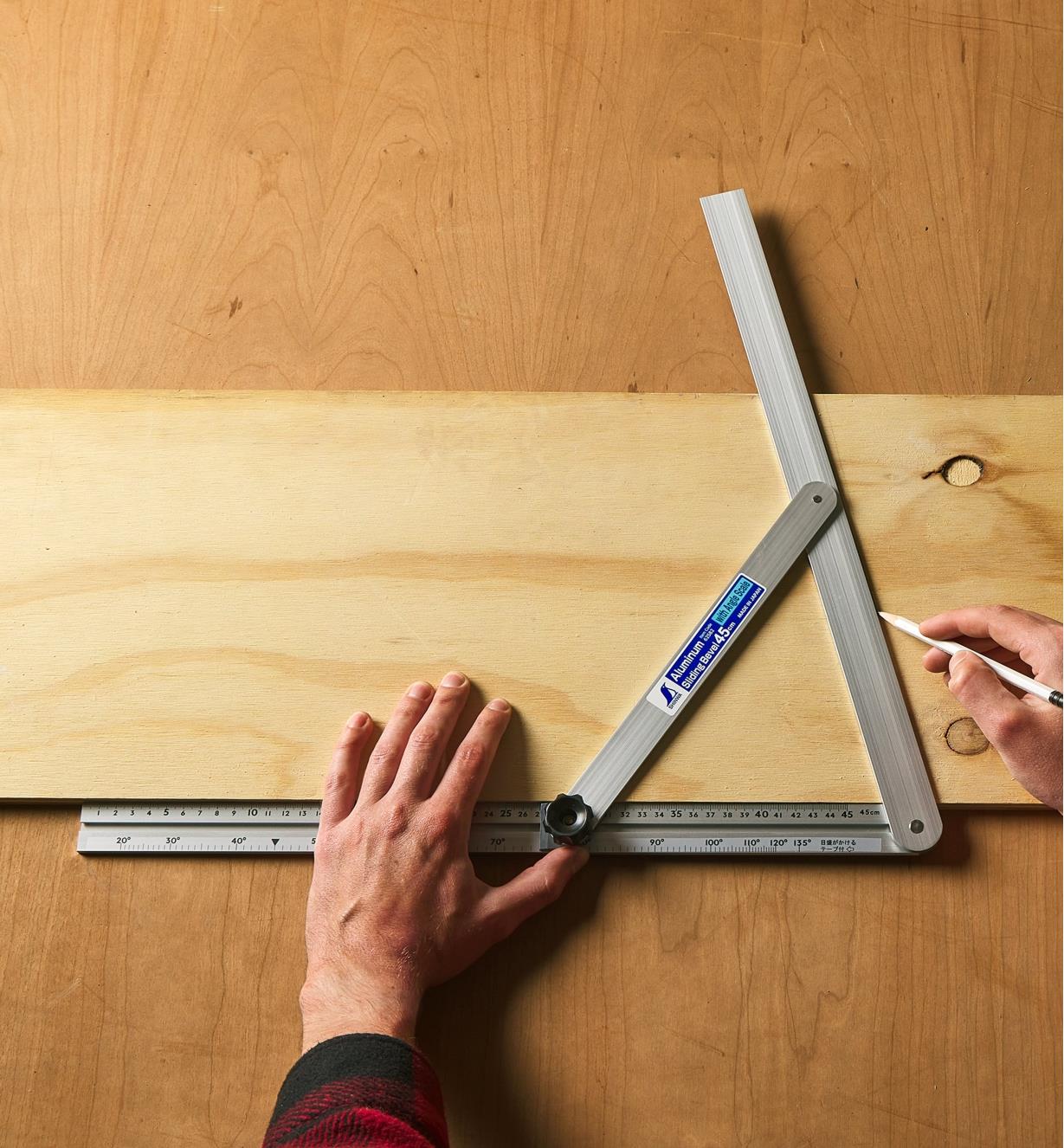 Using a large aluminum bevel to mark an angle on a board