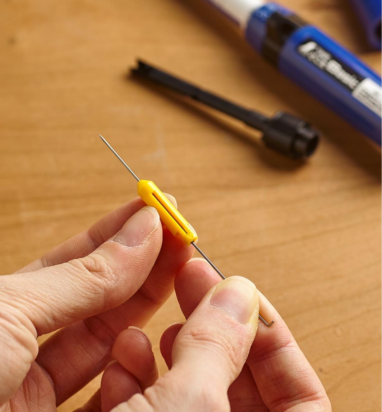 Inserting a needle into a holder