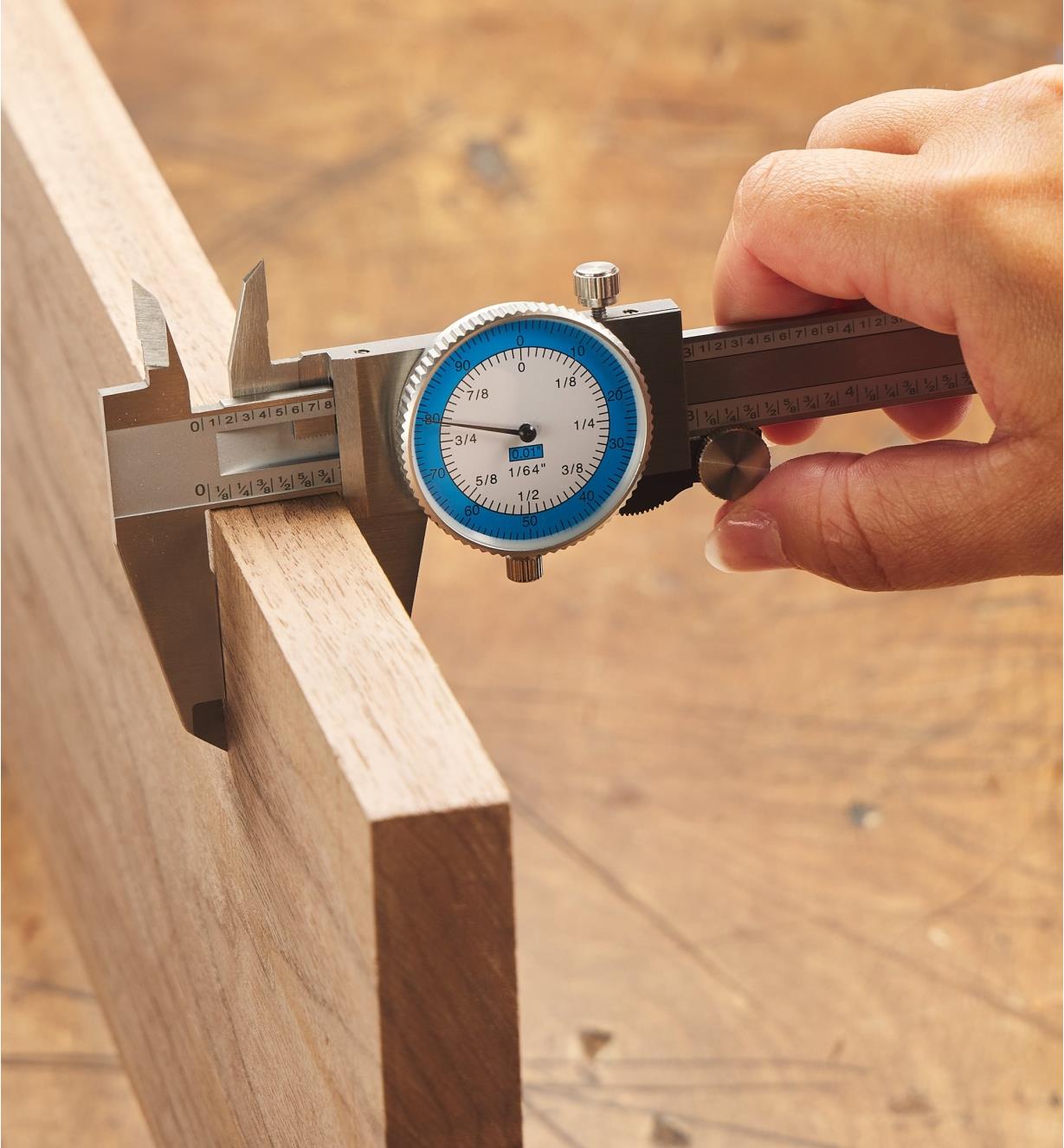 Measuring a board with the Fractional/Decimal Inch Combination Caliper