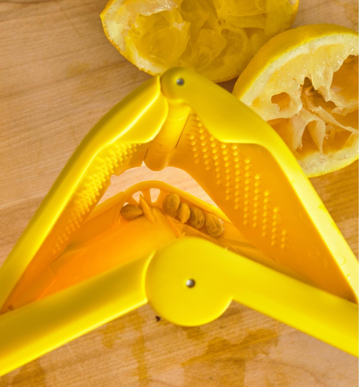 Pépins de citron se trouvant dans la passoire intégrée du presse-agrumes ergonomique