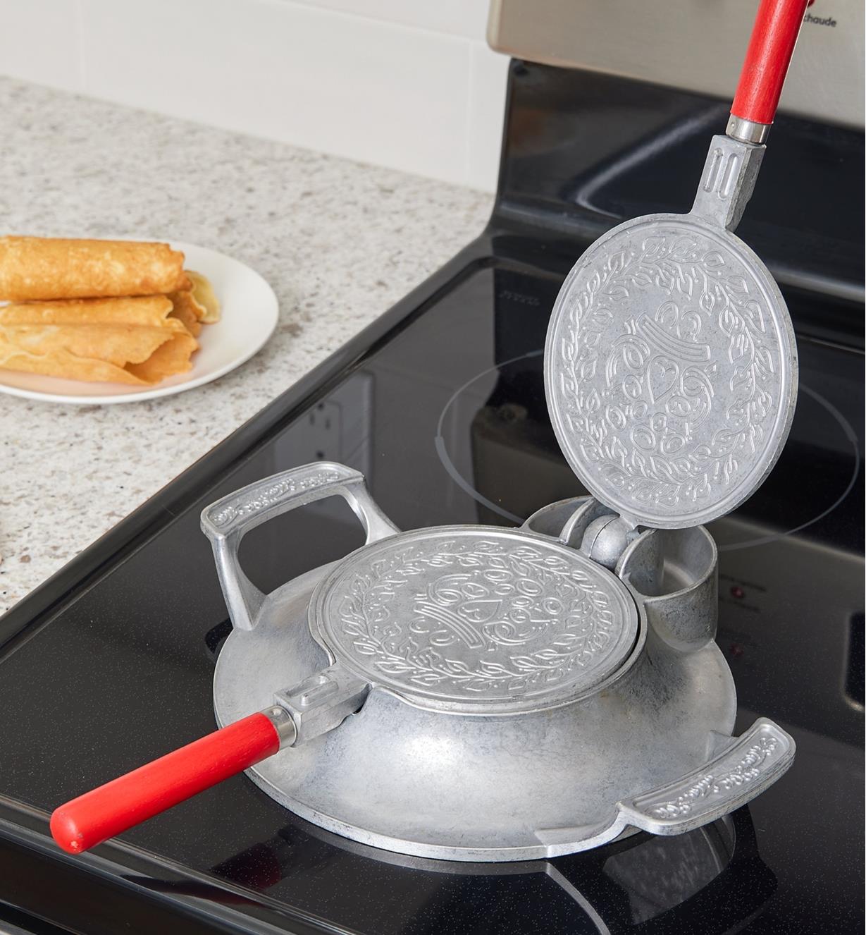 Heating the krumkake and pizzelle iron on a stove top
