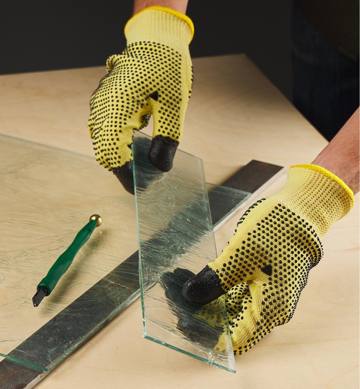 Holding a piece of cut glass while wearing cut-resistant gloves