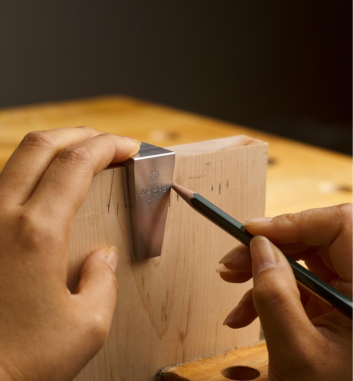A dovetail being laid out on wood along the angled side of a dovetail marker