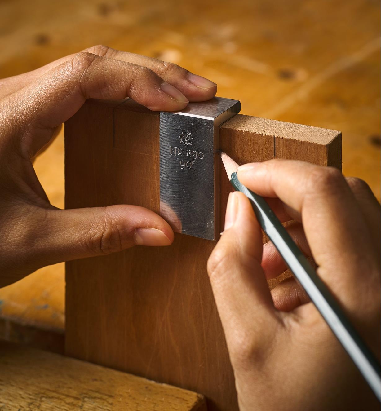 A line being laid out at the edge of a board with a saddle square