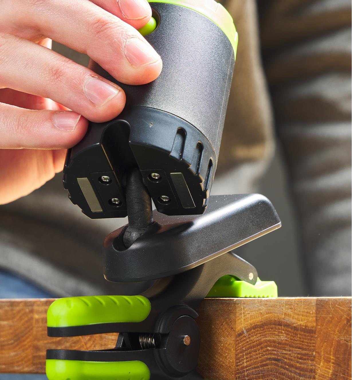A close-up view of the double swivel mechanism in the rechargeable clip light’s mounting base
