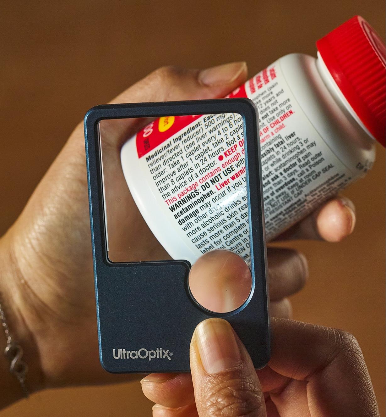 Using an LED pocket magnifier to read fine print on a medicine label