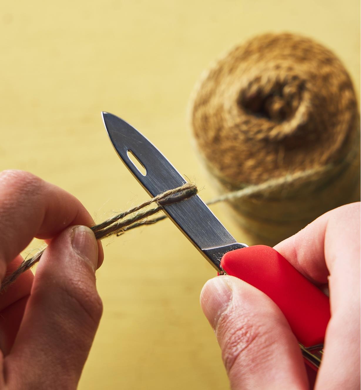 Cutting a piece of twine with a Felco pocket knife