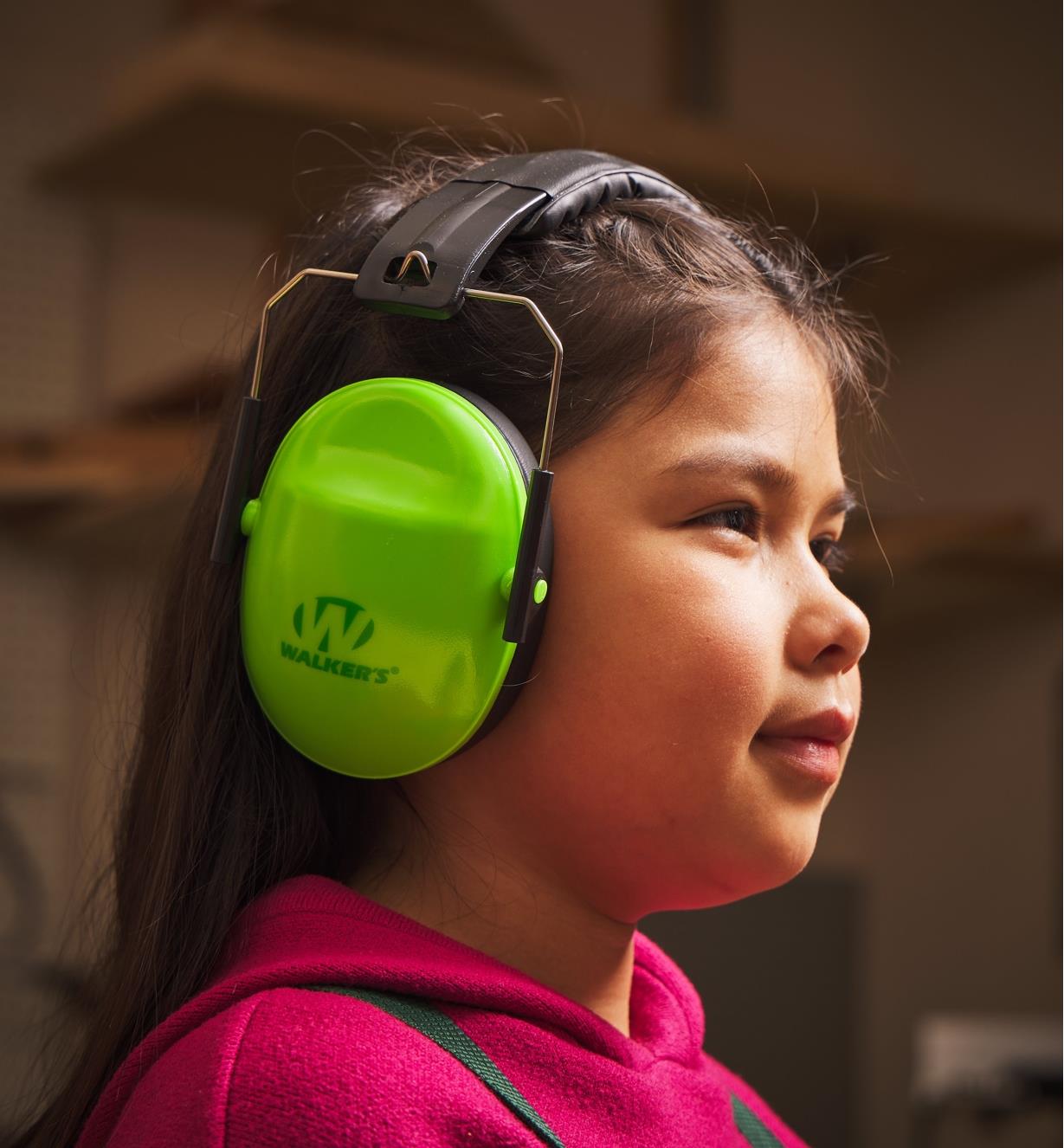 A child in profile wearing hearing protectors