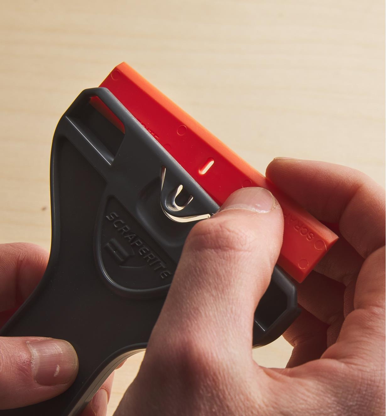 Placing a razor blade in a holder