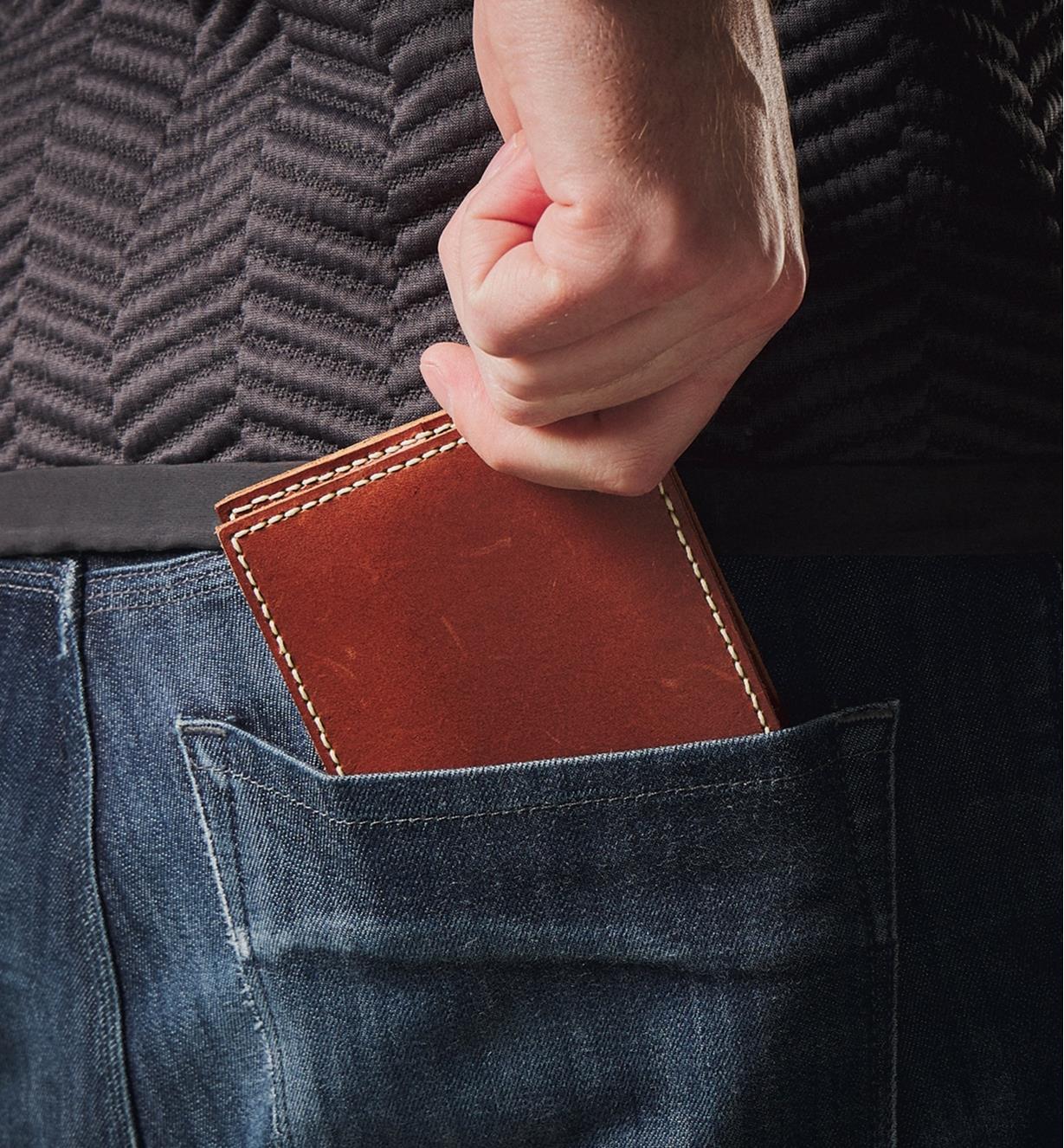 Putting a leather wallet into a back pants pocket