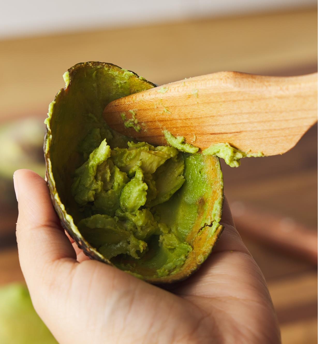 Scraping the inside of an avocado skin with a Better Spreader